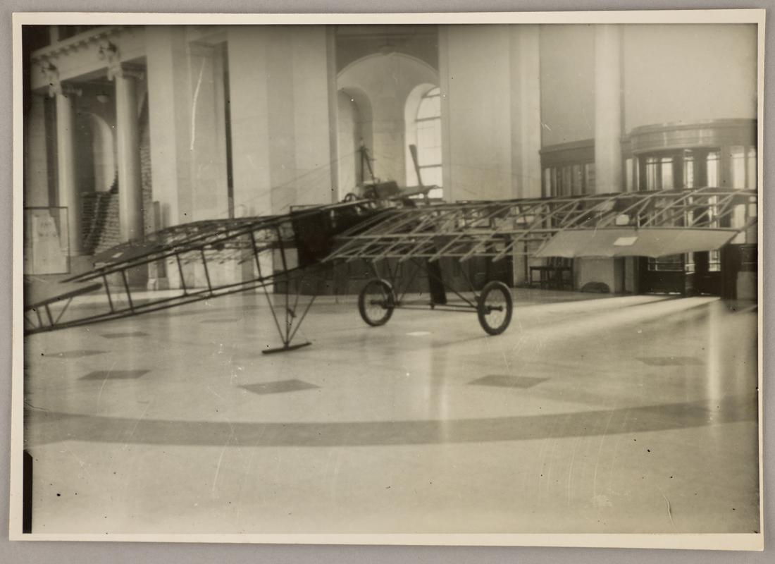 Photograph of Watkins monoplane in the main hall of the National Museum of Wales during the exhibition 'Wings for Victory', 1943. Inscription on reverse.