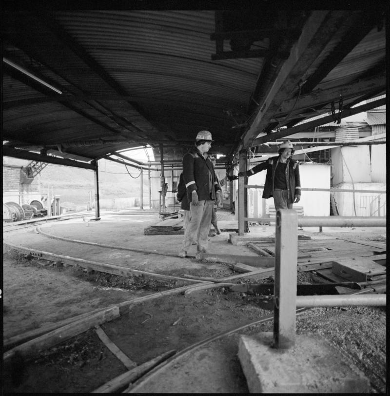 Black and white film negative showing two men at the tub circuit, Coegnant Colliery 25 November 1981.  '25 Nov 1981' is transcribed from original negative bag.