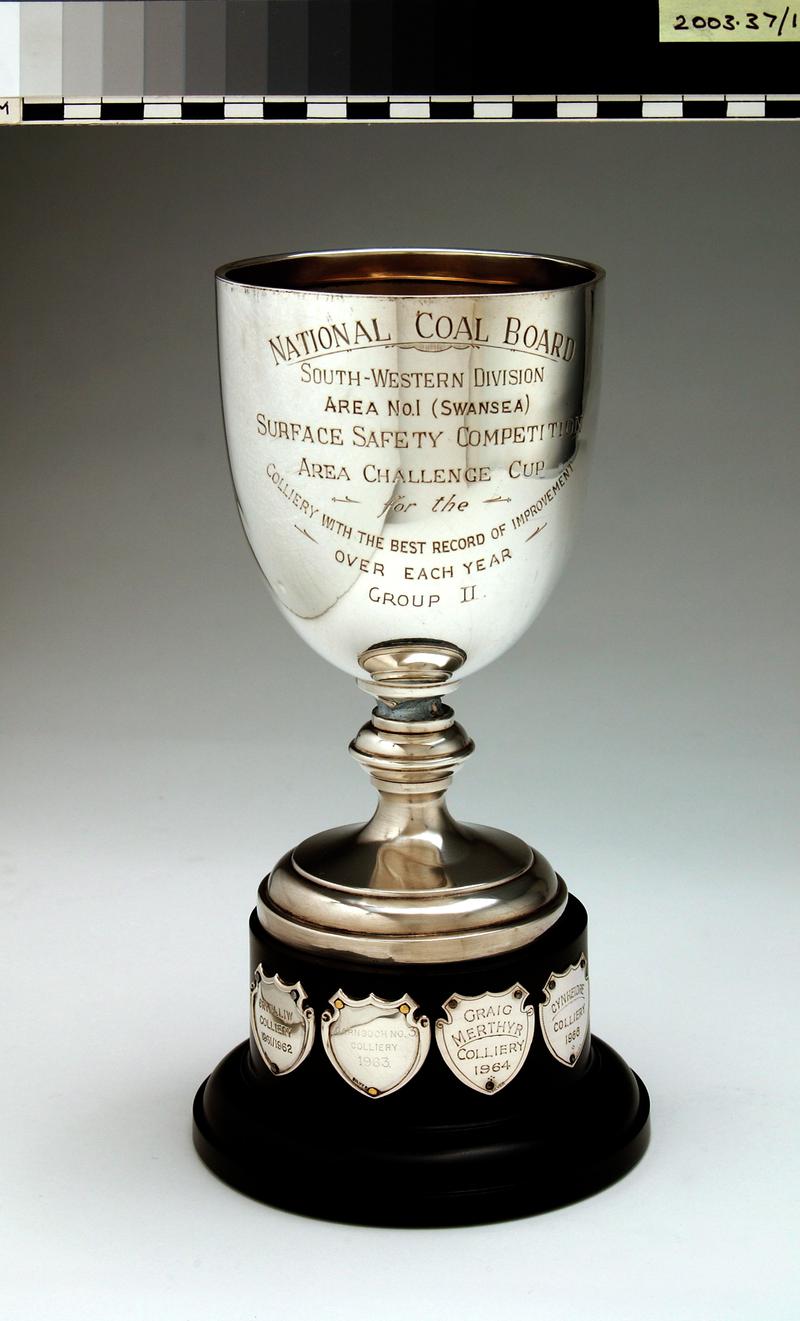 N.C.B Surface Competition Trophy Cup, on bakelite base with various small shields attached commemorating past winners