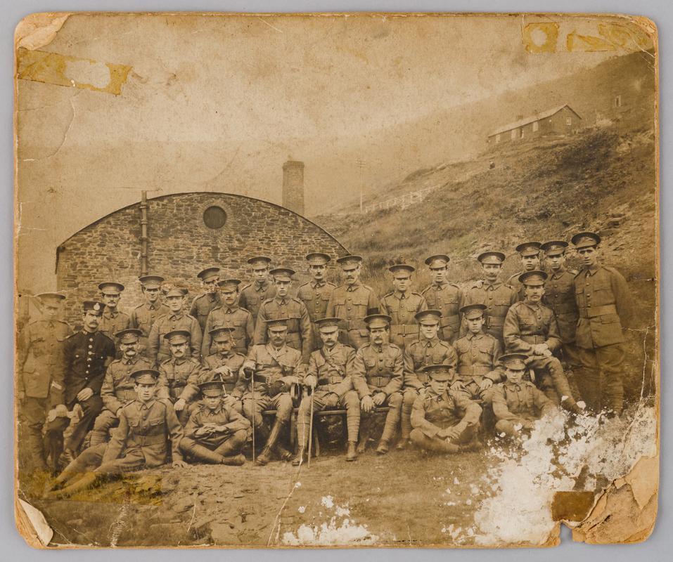 Soliders in uniform, badge appears to be that of Glamorgan Volunteer Training Corps. Workmen of Braich y Cymmer Colliery, c.1915.