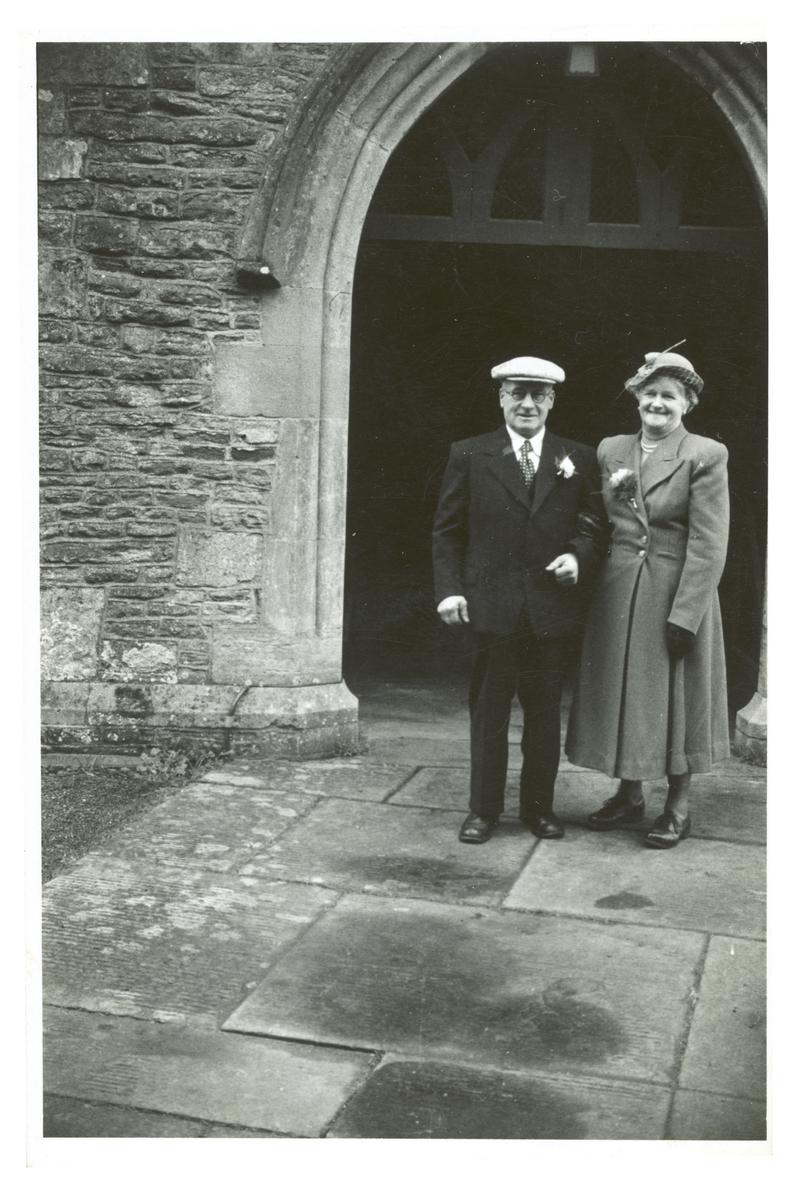 Photograph of Mr & Mrs William Targett outside a church at a wedding.