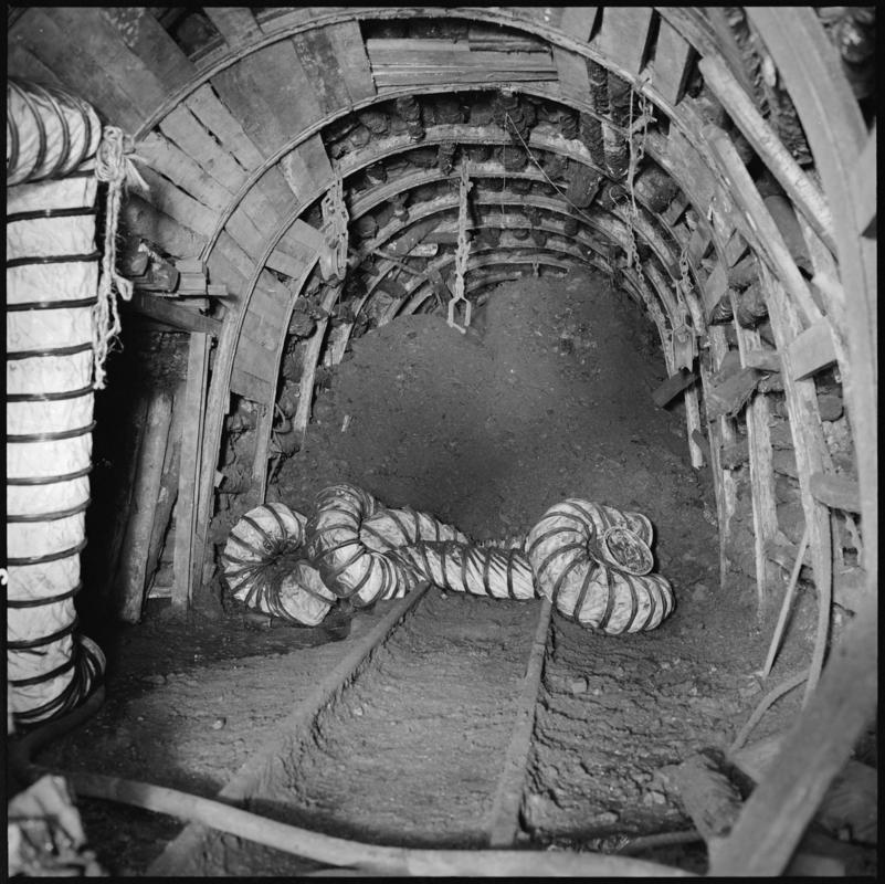 Black and white film negative showing a flexible ventilation bag in the roadway, Big Pit Colliery.