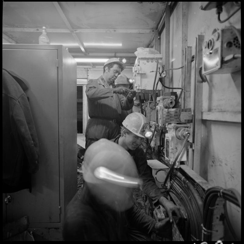 Black and white film negative showing men carrying out maintenance work, Lady Windsor Colliery.