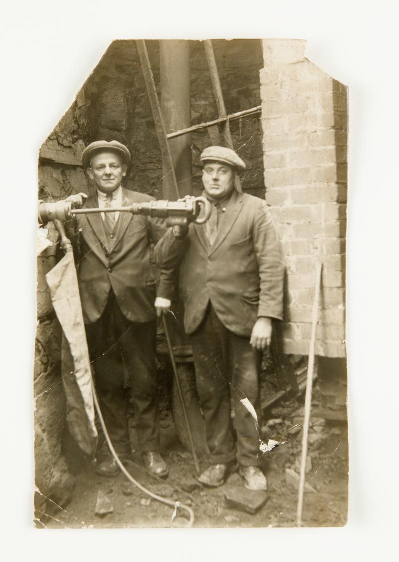 Photograph showing Stan Williams and John Evans with dust trap invention.