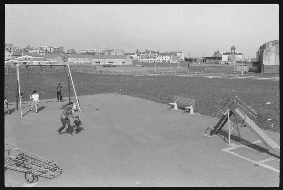 Children's playground at Louisa Place, with the Welsh Industrial and Maritime Museum building in background. Shows route of proposed new road.