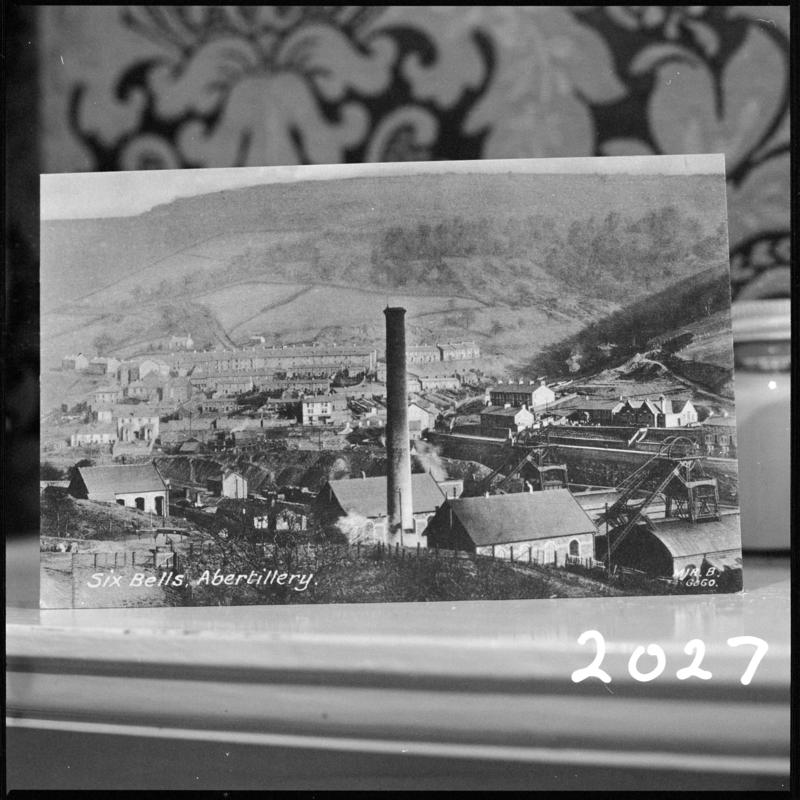 Black and white film negative of a photograph showing a landscape view of Six Bells Colliery, Abertillery and the town. 'Six Bells' is transcribed from original negative bag.