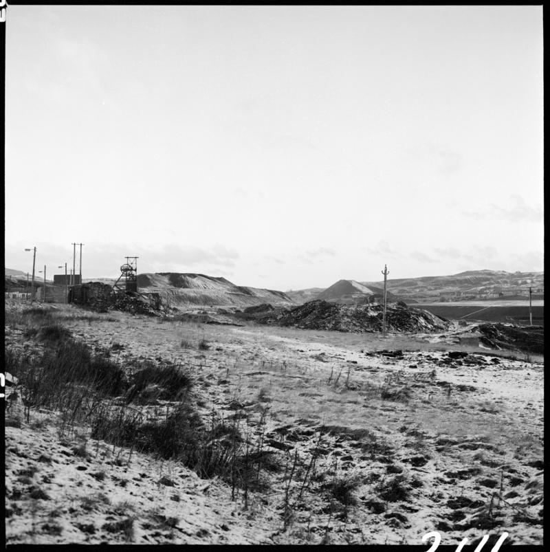 Black and white film negative showing the landscape surrounding Big Pit.  The headgear can be seen in the background, 28 November 1980.  'Blaenavon 28/11/80' is transcribed from original negative bag.