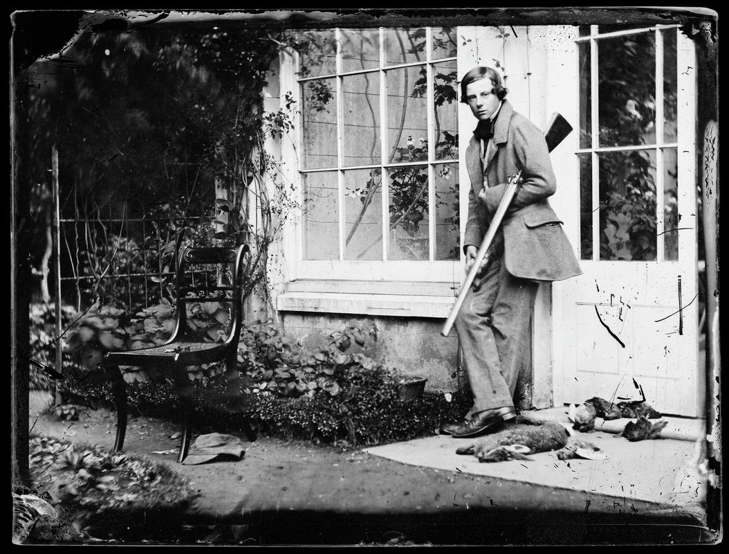 Johnny with gun and rabbits, glass negative