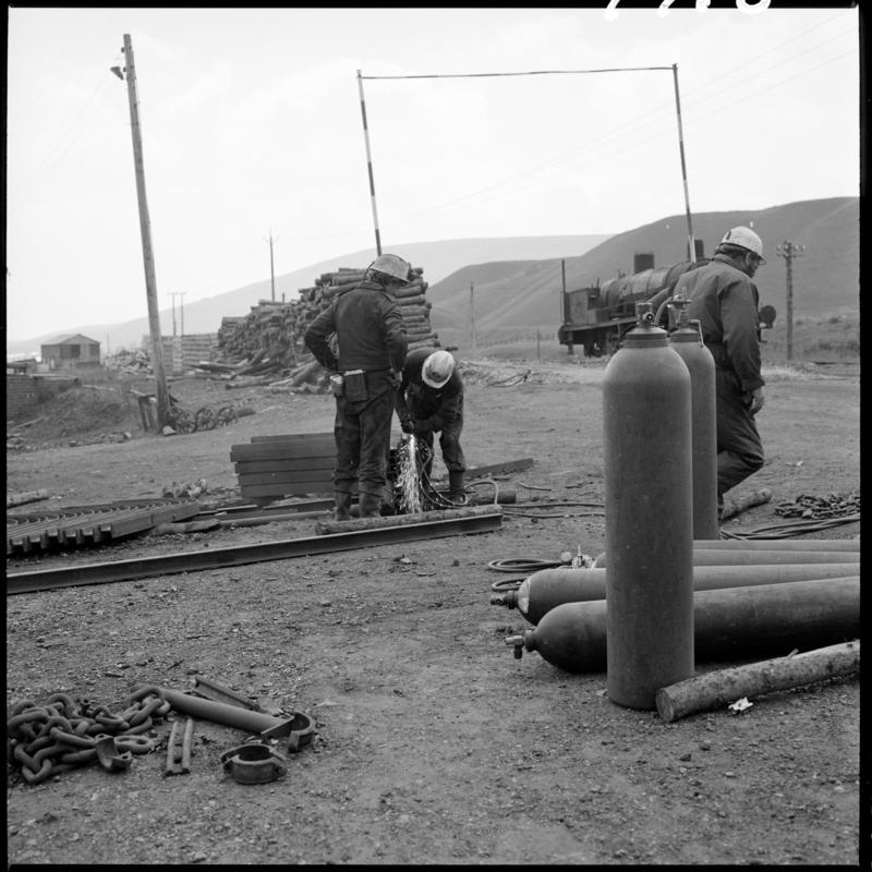 Black and white film negative showing two men working at the Blaenavon drift yard.