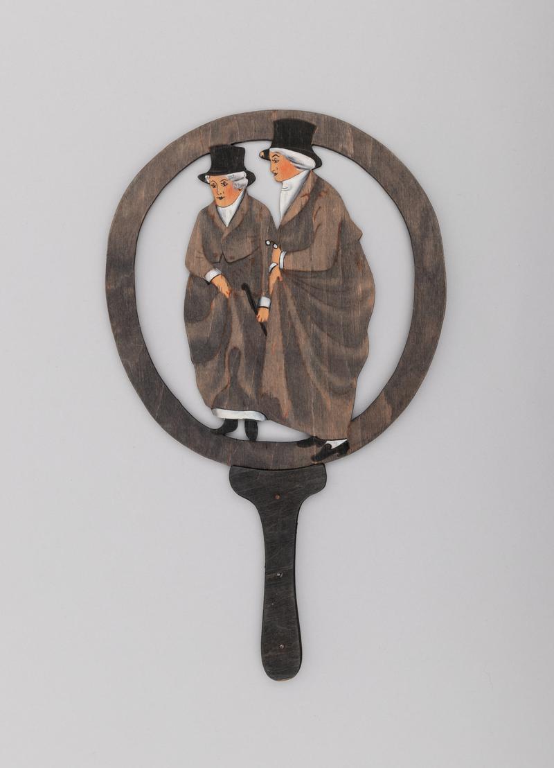Painted plywood hand held fire-screen (or possibly story-telling paddle), with detachable handle, depicting the Ladies of Llangollen.