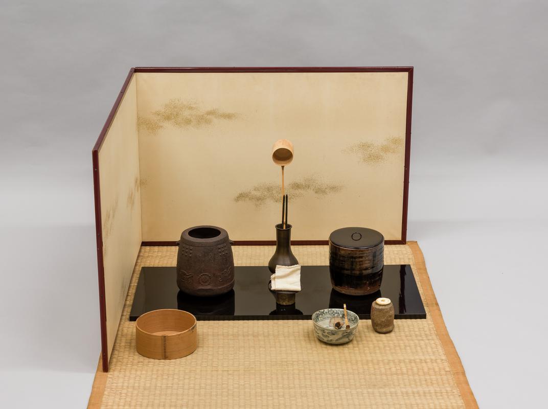 Tea service consisiting of: tatami mat, folding screen (byobu), lacquered board (naga ita), iron kettle (kama), water jar & lid, tea bowl (chawan), tea jar (chaire), lid-rest (futa oki), bamboo tea scoop (chashaku), cedar-wood slop bowl (koboshi), bamboo ladle (shaku), bamboo whisk, bronze ladle stand (shaku tate), pair of iron chopsticks (hibashi), linen cloth.