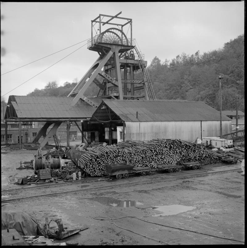 Black and white film negative of a photograph showing Celynen South Colliery downcast headgear and timber yard, 6 November 1985.  'South Celynen 6 Nov 1985' is transcribed from original negative bag.