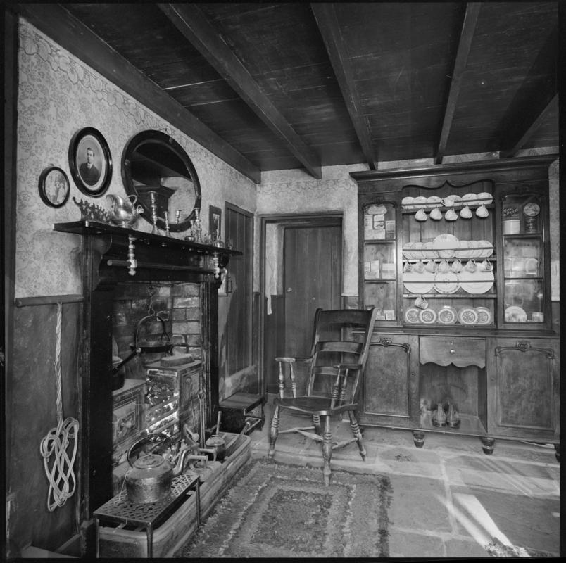 Black and white film negative showing the interior of a cottage, Blaenavon.