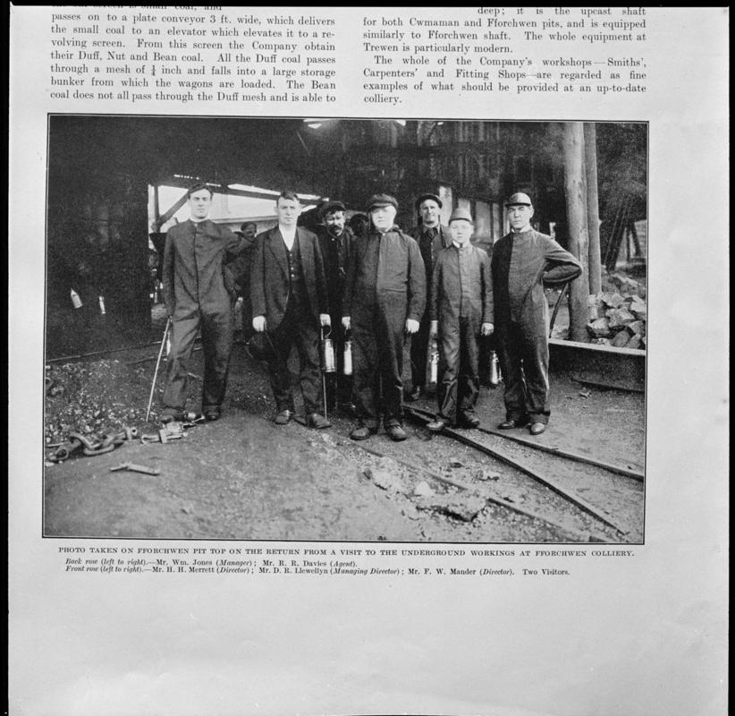 Black and white film negative showing men at pit top after returning from underground, Fforchwen Colliery, photographed from a publication.  'Fforchwen Colliery' is transcribed from original negative bag.