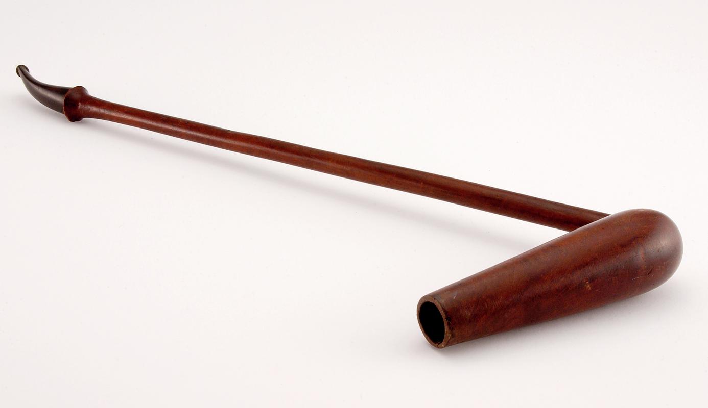 Pipe, Malaysian, imported to Wales.  Curved stem, plastic mouthpiece and long fid-shaped bowl.