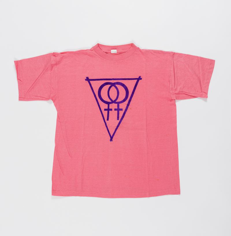 Pink t-shirt with double womens symbol within a triangle. Worn on women's rights marches and Pride.
