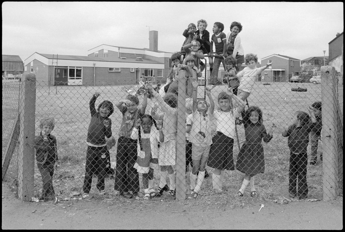 School children on climbing frame in the playground with Mountstuart Primary School in the background.