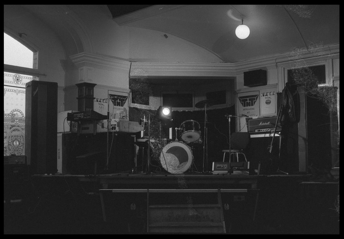 Musical instruments in corner of room. Possibly belonging to the TNT Group. Location unknown.