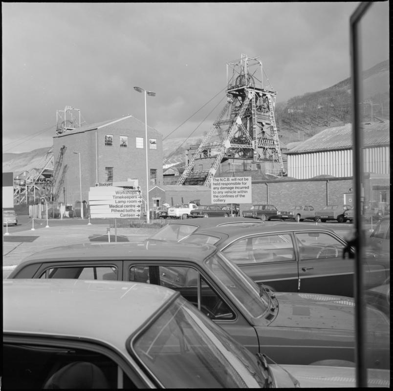 Black and white film negative showing Merthyr Vale Colliery and carpark, 1976.  'Merthyr Vale 1976' is transcribed from original negative bag.