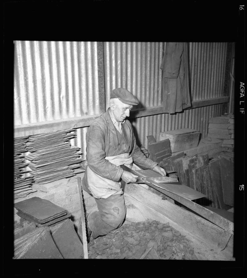 Quarryman dressing a roofing slate using a slate trimming knife, 'cyllell naddu/cyllell bach', Dinorwig Quarry, early 1960s.



According to Emyr Jones, this quarryman was the only one in Dinorwig Quarry still using a trimming knife.