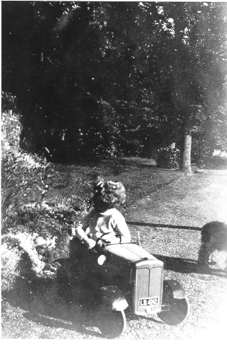 Dinorwig Quarry Hospital. Vivian Hughes playing with a toy car in the gardens