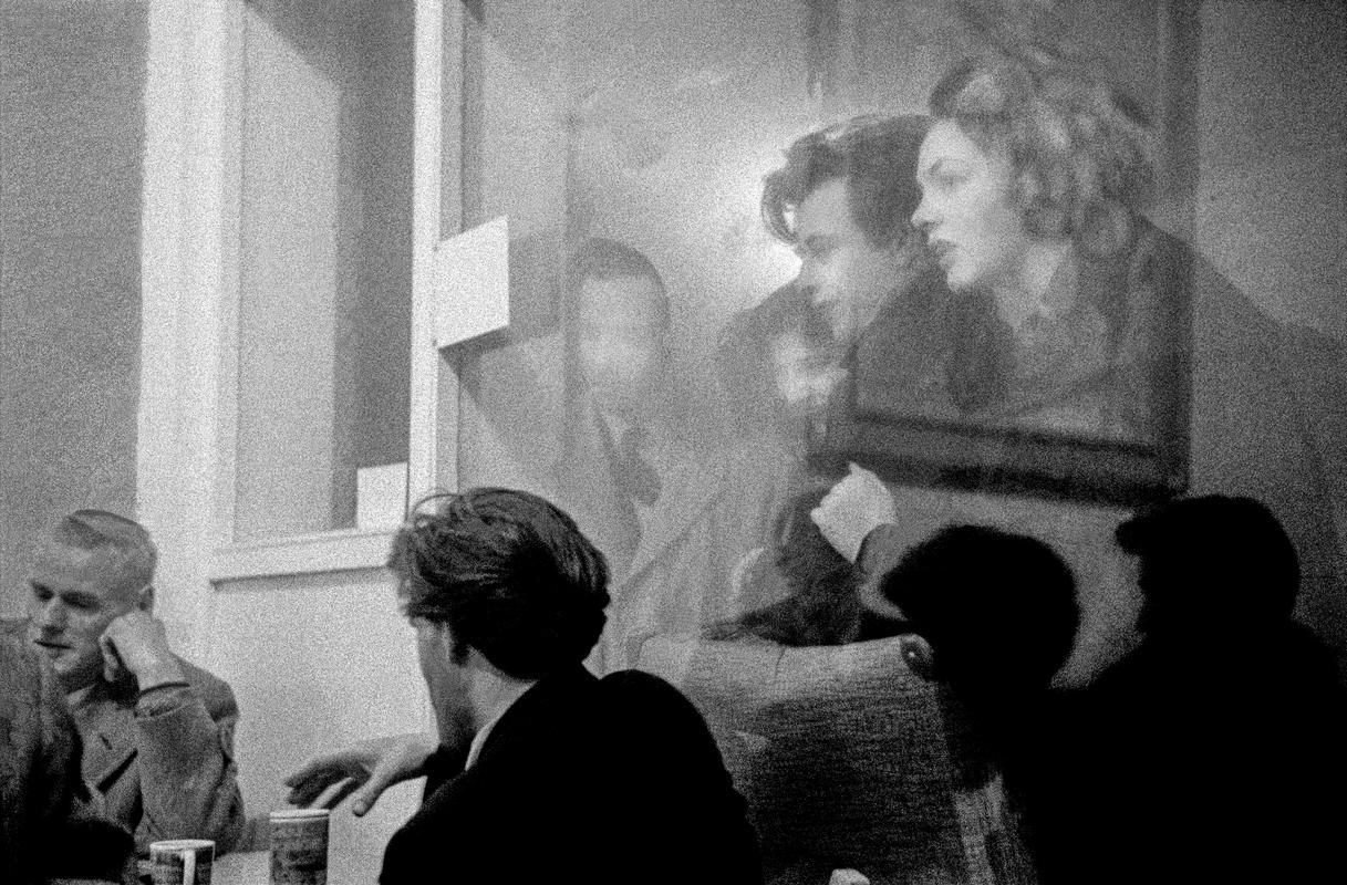 GB. ENGLAND. London. Fifties cultural meeting place. The Partisan Coffee-Bar in Soho London. Meeting place of the left wing activists of the period. People in the street outside gaze through the large plate glass window at friends inside. Taken on a Contax 2 camera (first professional camera). 1957.