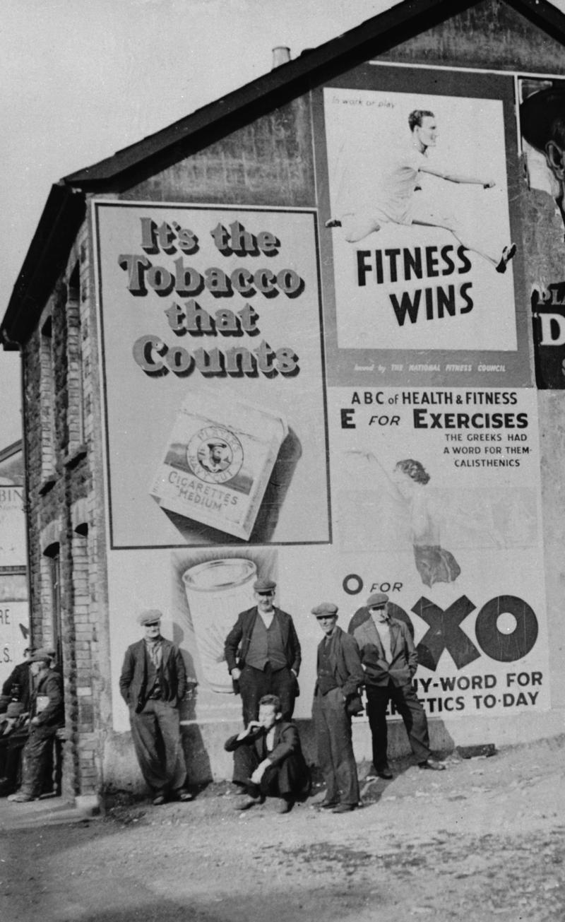 Cambrian Combine Strike. Miners on street corner with advertisements