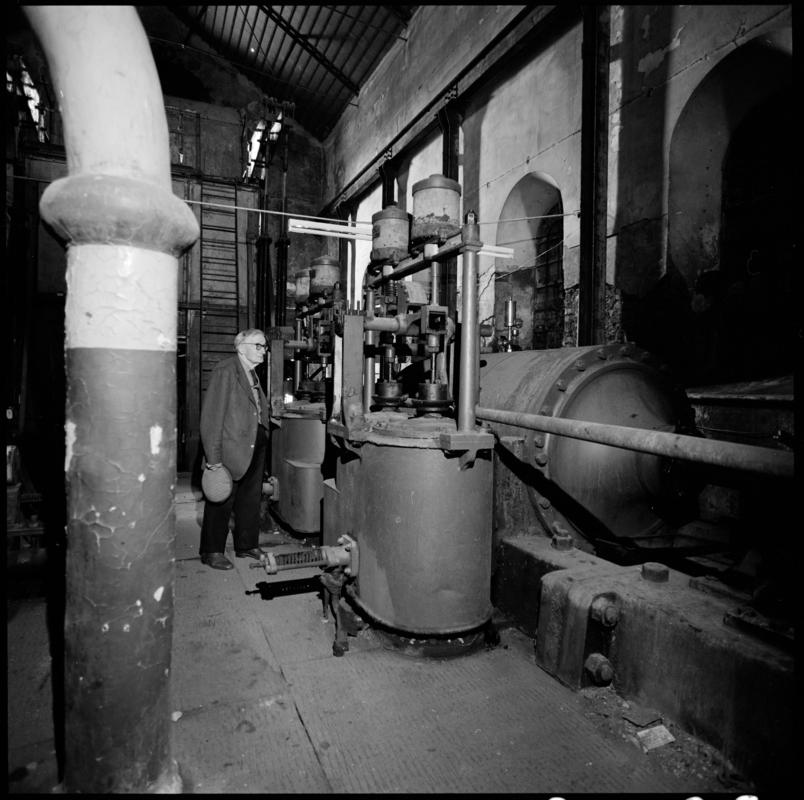 Black and white film negative showing George Watkins in the winding engine house, Elliot Colliery.  'East Elliot' is transcribed from original negative bag.