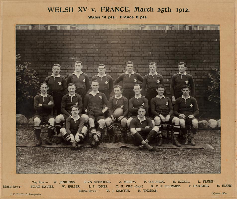 Photograph of Welsh rugby team, with names printed below. Mounted on card. On card above image : Wales XV v France March 25th 1912. Wales 14pts, France 8pts.