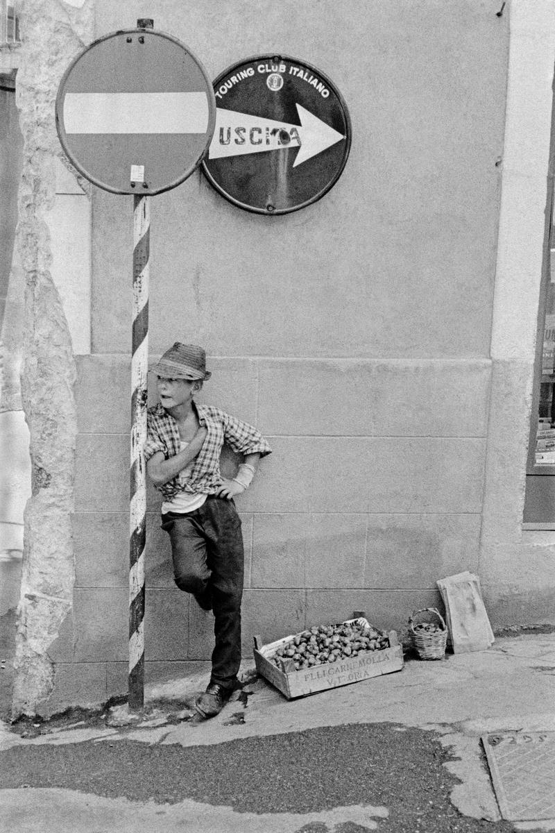 ITALY. Sicily. Taormina. Young fruit seller. 1964.