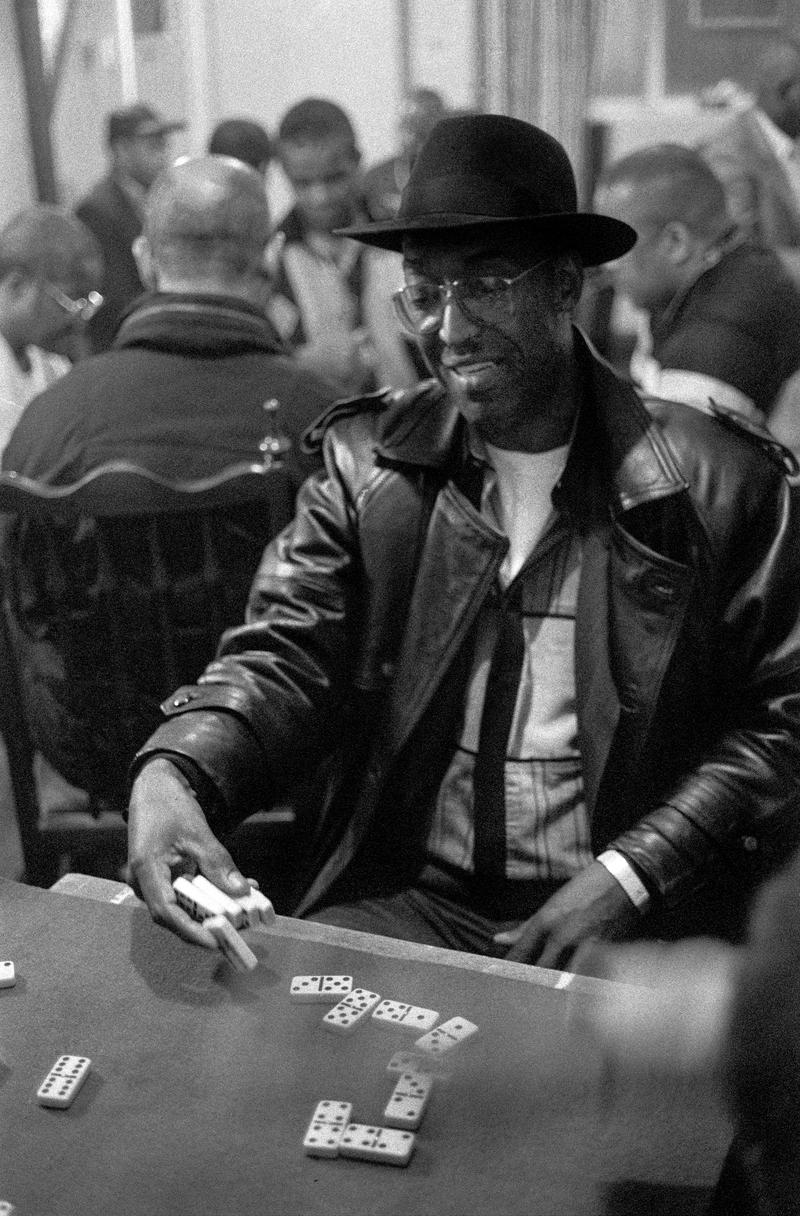 GB. WALES. Cardiff. Butetown - once know as 'Tiger Bay'. Laying down the cards at a domino match between Cardiff and London held above Bab's Bistro (now the Caribean Restraurant), West Bute Street. The player was representing the visiting side. 2000