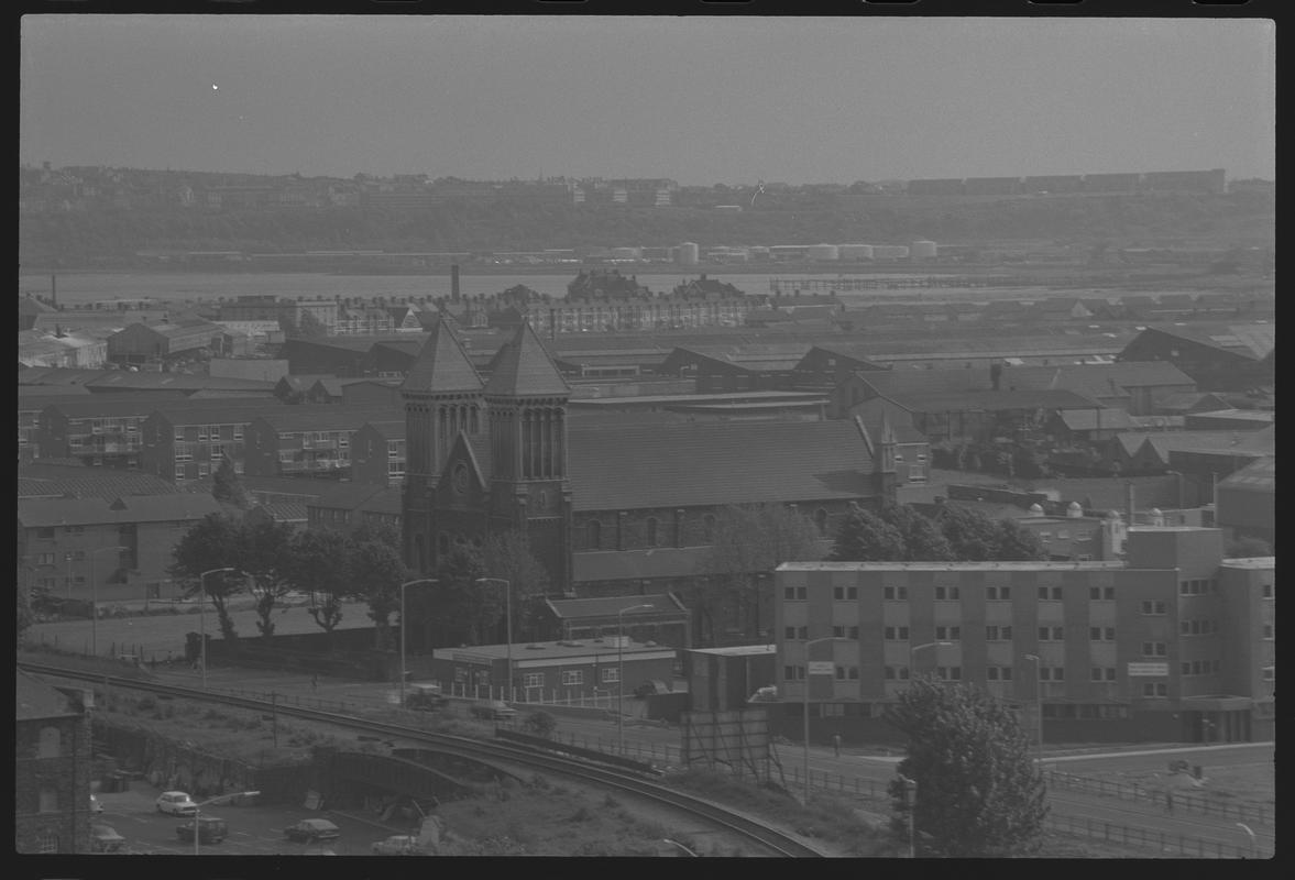 View looking south west over Butetown, with St Mary's Church and Salvation Army Hostel in foreground, and Penarth in background.