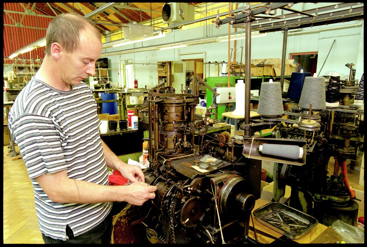 Peter Wood setting up an automatic sock knitting machine at Corgi Hosiery Ltd factory, Ammanford, 1 July 2002.