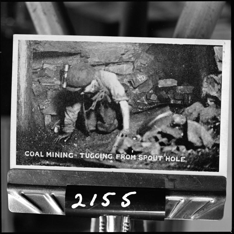 Black and white film negative of a photograph showing the 'tugging from spout hole' (information taken from the caption on the photograph), unidentified colliery.  'Tugging' is transcribed from original negative bag.