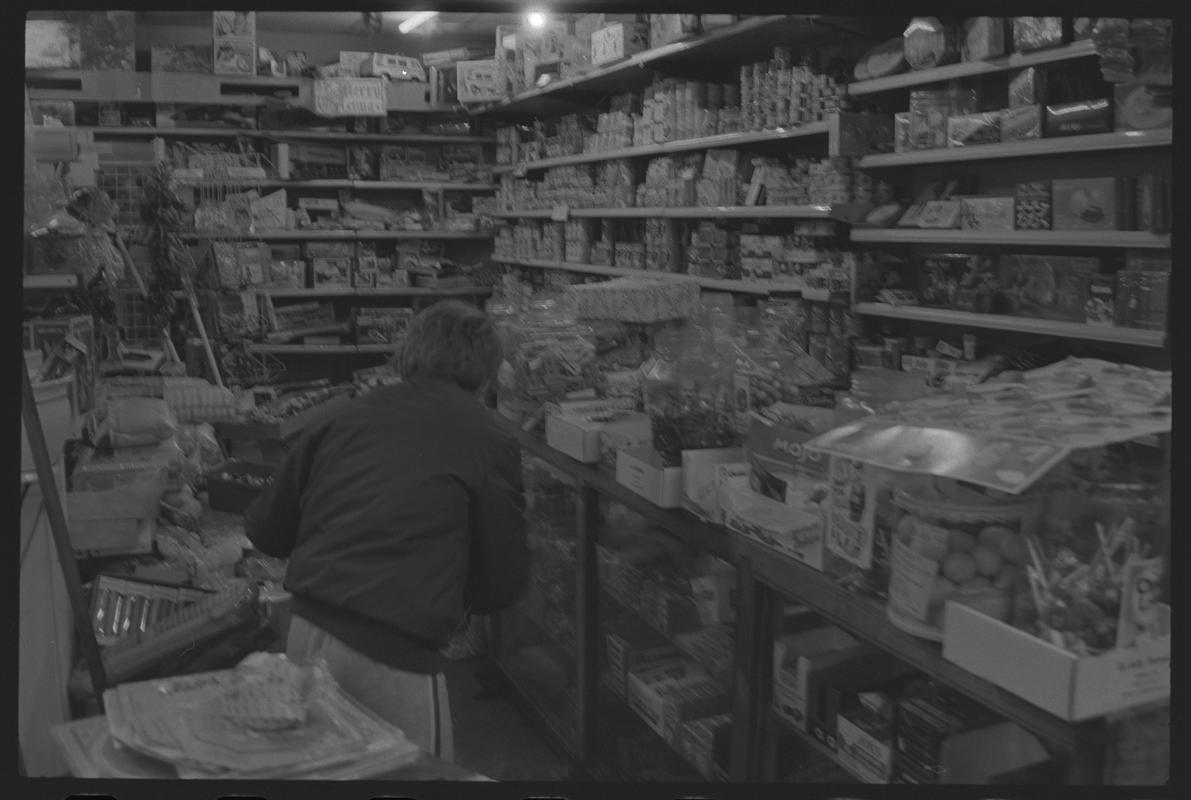 Child at counter in newsagents, Loudoun Square, Butetown.