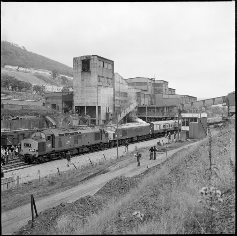 Black and white film negative showing a locomotive passing through Abertillery New Mine, 1977. '1977' is transcribed from original negative bag.