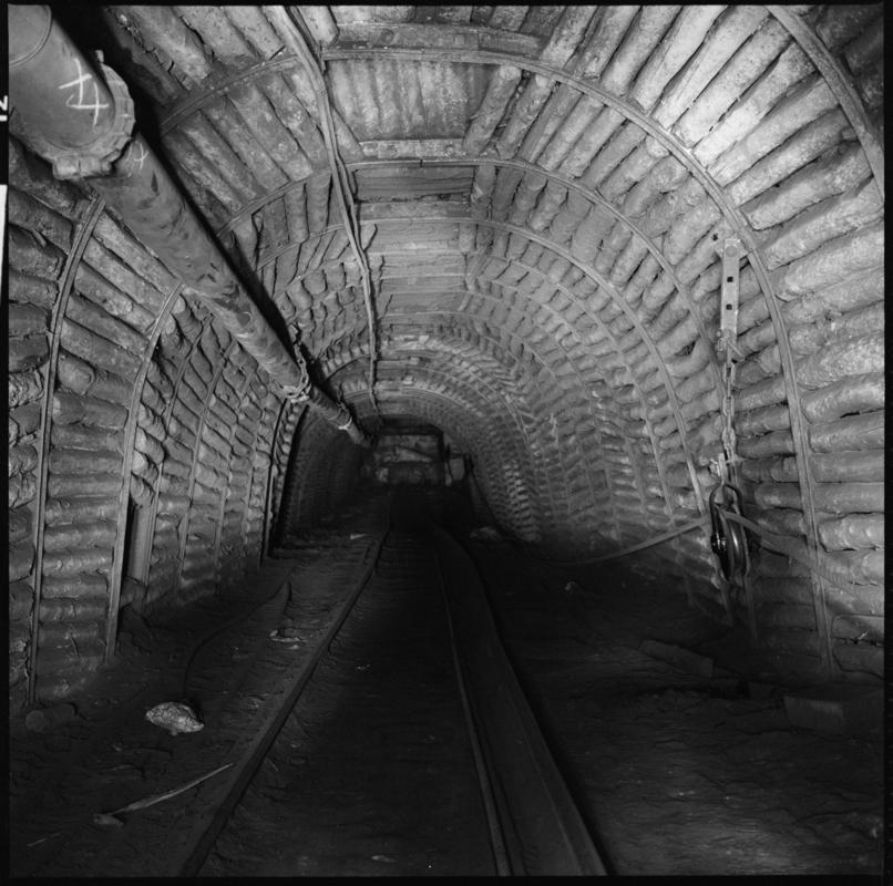 Black and white film negative showing an underground roadway, Tymawr Colliery 21 December 1976.  'Ty Mawr 21/Dec/76' is transcribed from original negative bag.