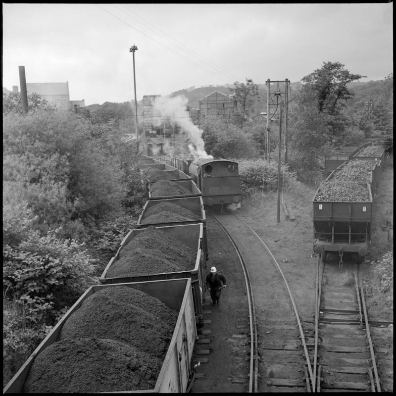 Black and white film negative showing a locomotive and wagons full of coal, 1975.  'Deep Duffryn 1975' is transcribed from original negative bag.