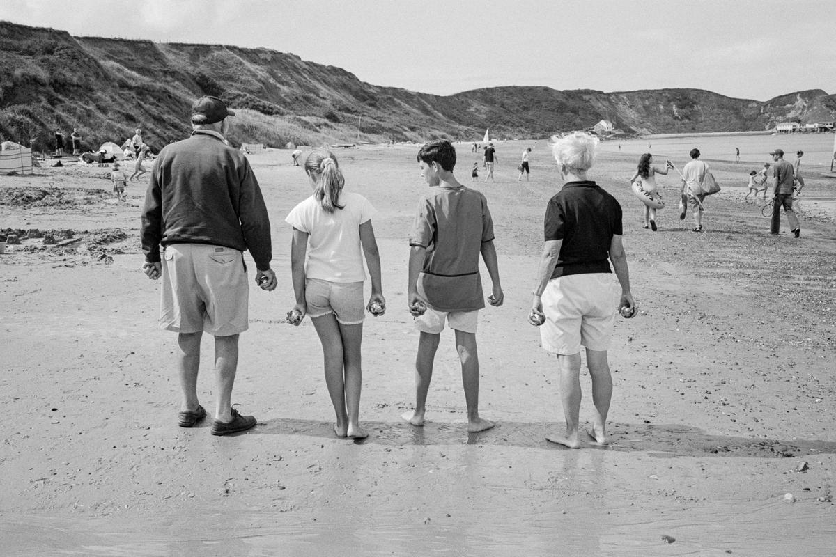 GB. WALES. Porth Dinllaen. Playing Boule on the beach. Europe comes to North Wales. 2004.