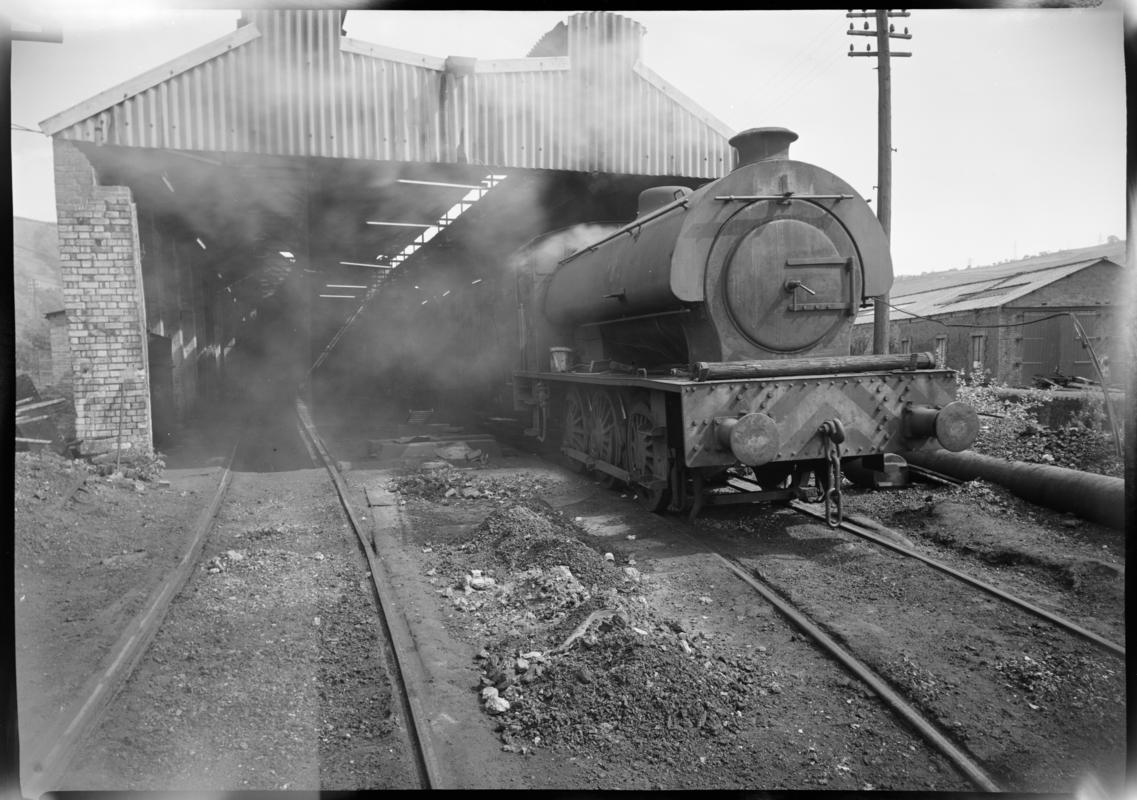 Black and white film negative showing a locomotive at the Mountain Ash locomotive shed, Nixon's Navigation Colliery.