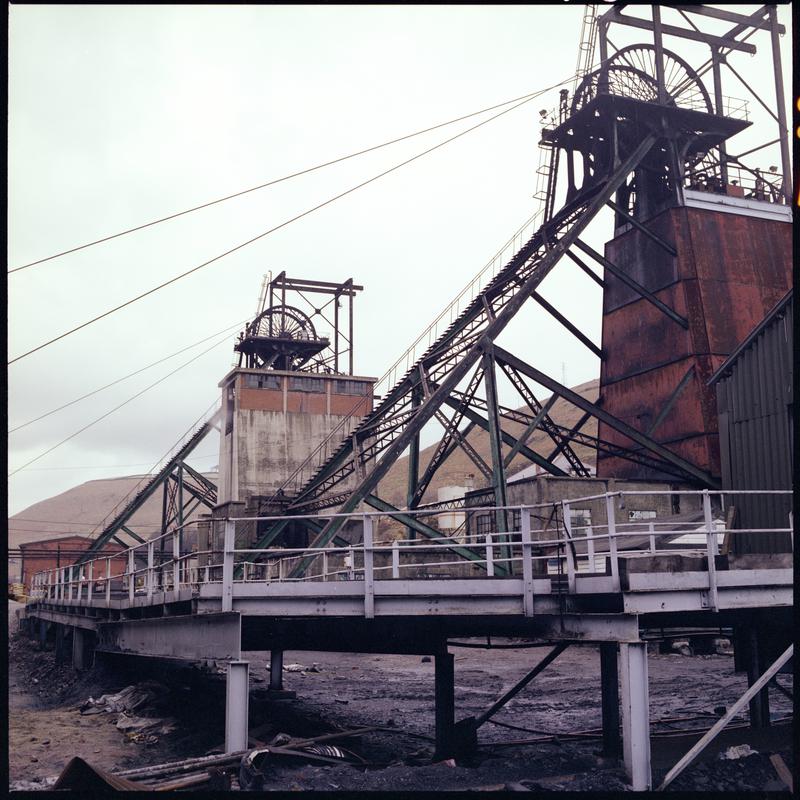 Colour film negative showing the upcast and downcast headframes, Taff Merthyr Colliery.