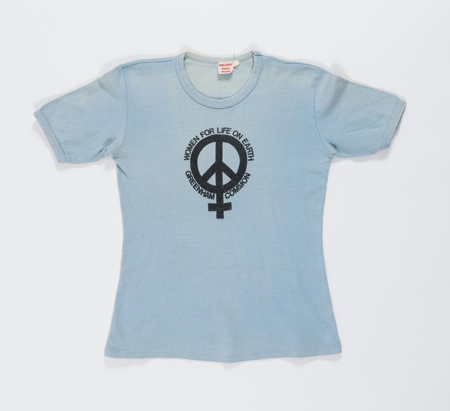 Blue 'Women For Life on Earth Greenham Common' t-shirt worn by Thalia Campbell