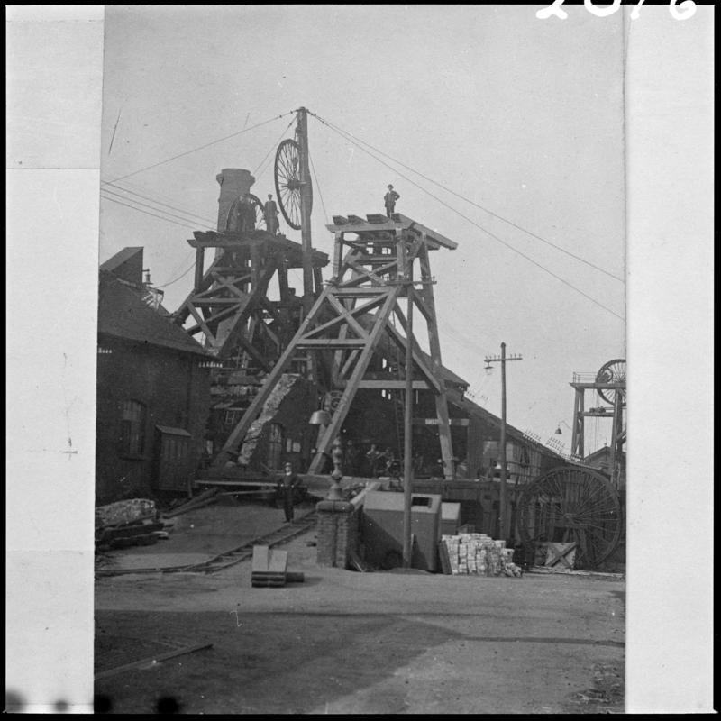 Black and white film negative of a photograph showing a wooden headframe, unknown colliery.  'Wood headframe, unknown pit' is transcribed from original negative bag.