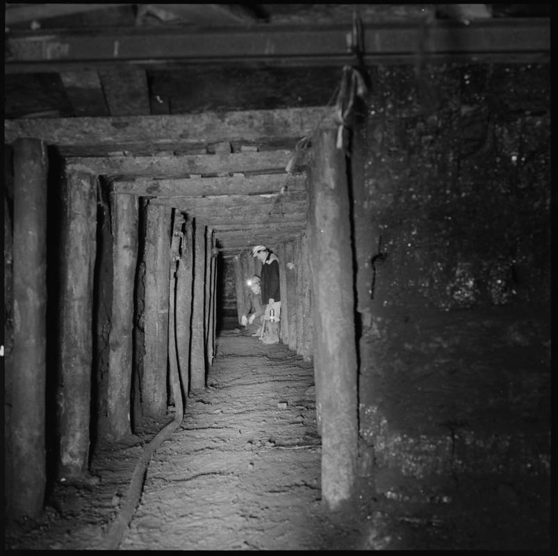 Black and white film negative showing two men at a timbered longwall face, Big Pit Colliery.