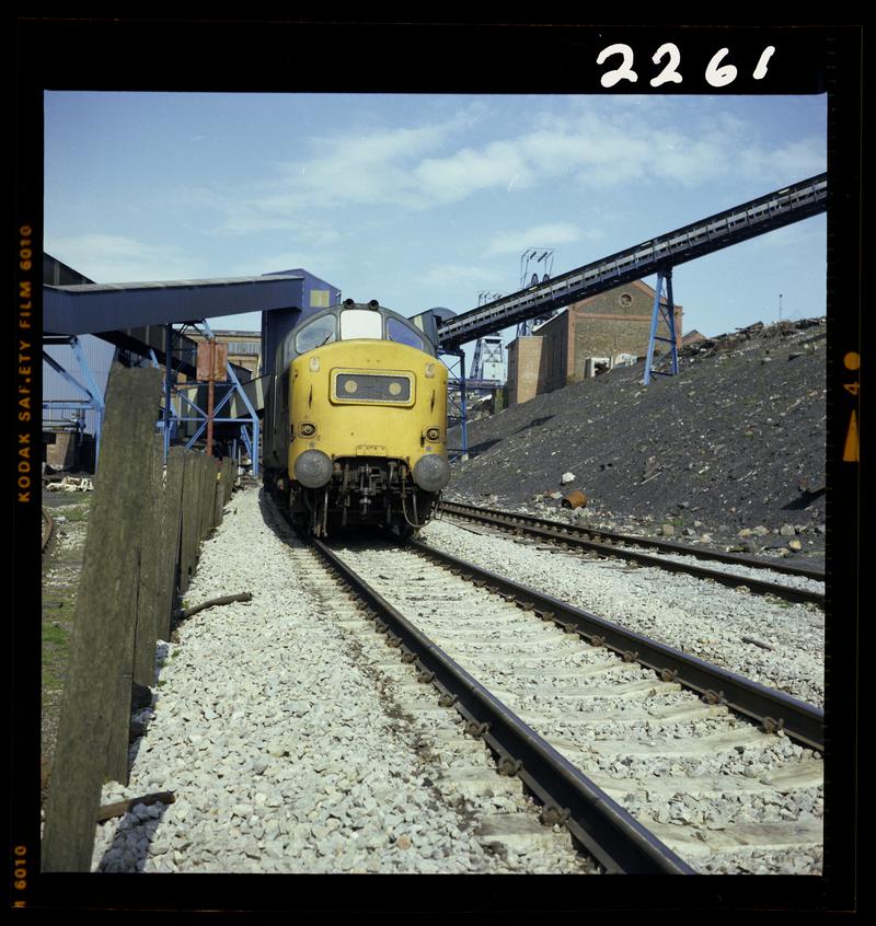 Colour film negative showing a locomotive passing through Oakdale Colliery, 16 April 1981.  'Oakdale 16/4/81' is transcribed from original negative bag.