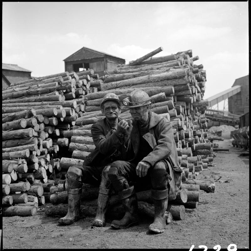 Peter 'Punchy' Clarke (on left) and Wilf Jones, having a cigarette in the timber yard at the end of the morning shift, Big Pit 1978.