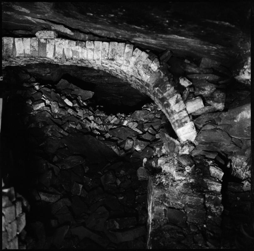 Black and white film negative showing the remains of the ventilation furnace at Tymawr Colliery.  The furnace was situated on the No. 3 landing in the Hetty shaft.  'Hetty furnace' is transcribed from original negative bag.