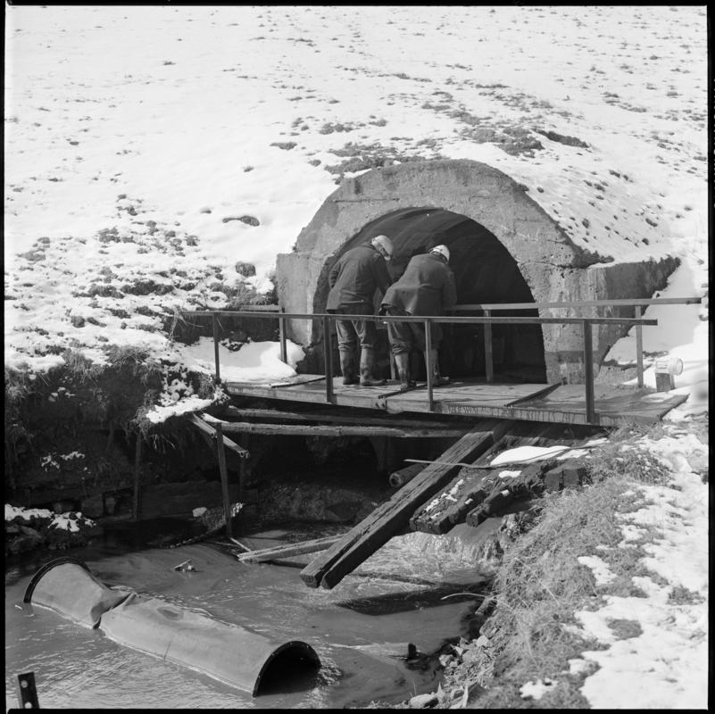 Black and white film negative showing two men at River Arch, Big Pit Colliery.  'River Arch Blaenavon' is transcribed from original negative bag.