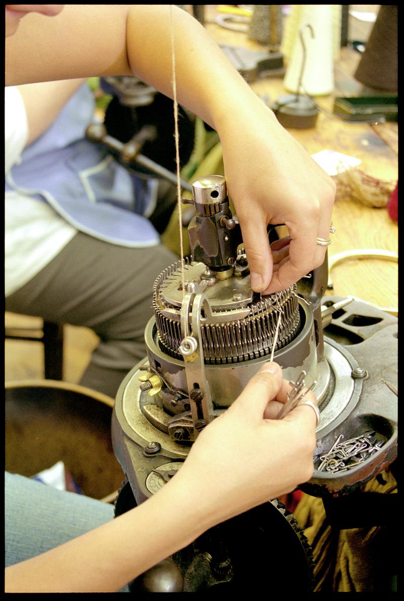 Donna Richards pulling needles out of use to turn a sock heel at Corgi Hosiery Ltd factory, Ammanford, 1 July 2002.