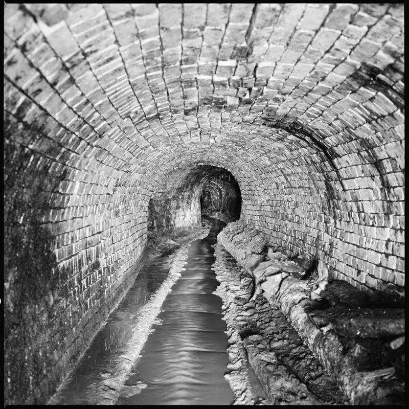 Black and white film negative showing a brick lined level in the Blaenavon complex, probably the Forge Level, 1975.